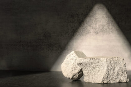 Rough stone with sunlight from window on concrete wall and floor